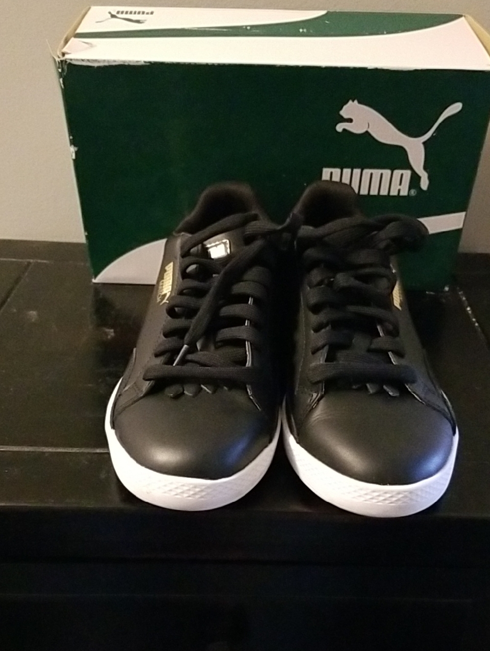 Puma Black Sneakers with White Soles and Gold Logo